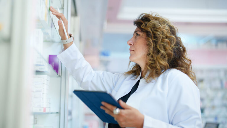 Pharmacy professional looking at pharmacy at shelves