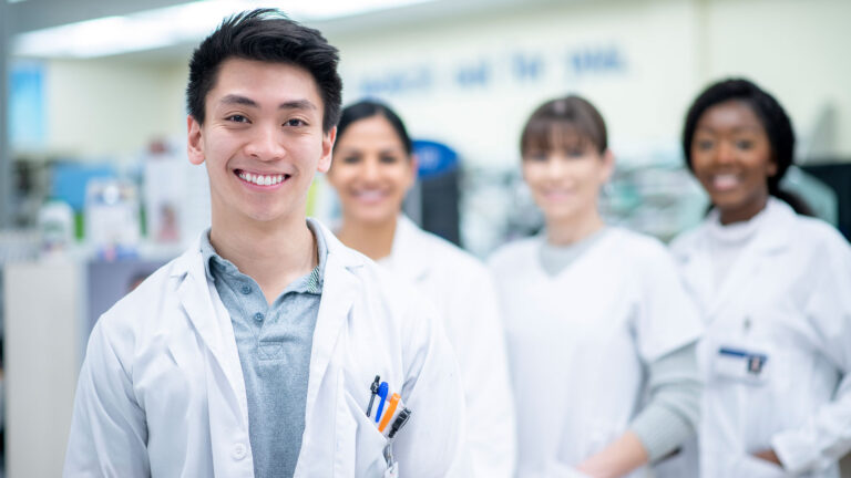 Pharmacy professionals standing together in the pharmacy